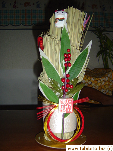 Our Kadomatsu from three years ago. The Manekineko (Beckoning Cat) adds wealth and luck to all those good things this set-up is supposed to bring us