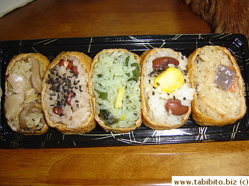 Tofu pockets stuffed with different rice fillings. The tofu pockets are simmered in special sauce before they are stuffed and they are actually a little too sweet for our liking.
