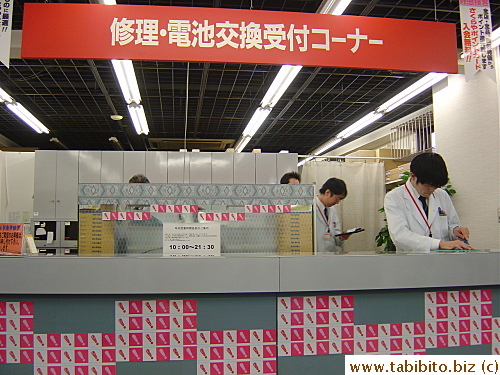 Service counter for watch repairs and battery change. Each technician dons a lab coat and looks very professional
