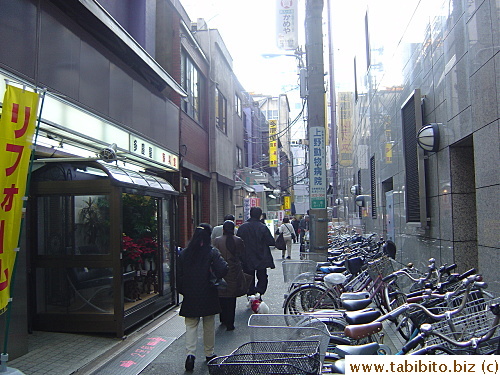 The short purple building further down this alley is also part of Takeya