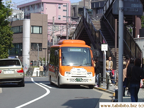 A Hachiko bus pulls up at a bus stop