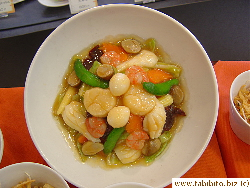 The misleading replica features big plump scallops and chunks of seafood