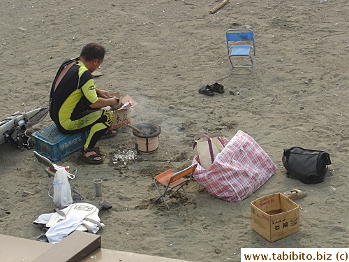 This hungry man couldn't wait to grill his catch on the beach