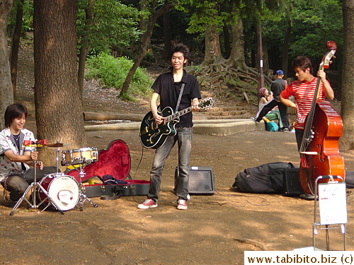 Three young musicians take a break between performance