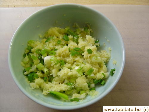The ginger is mixed with the chopped green onions