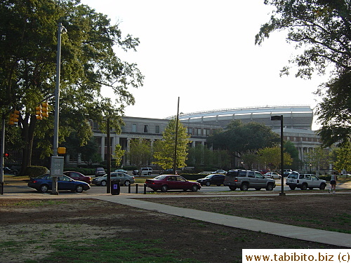 The building behind the trees is Rose Administration. In the background is part of the circular exterior of a very large stadium being built
