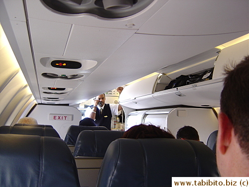 The aisle is narrow and overhead bins are small.  Larger carry-on bags have to be stowed separately in the back of the plane.  Our lone flight attendant is a very funny guy.  His first announcement on the plane was, 