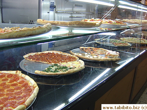 Typical pizza place in NY. (This one is Pronto Pizza) A variety of pizza is put out for customers to choose from