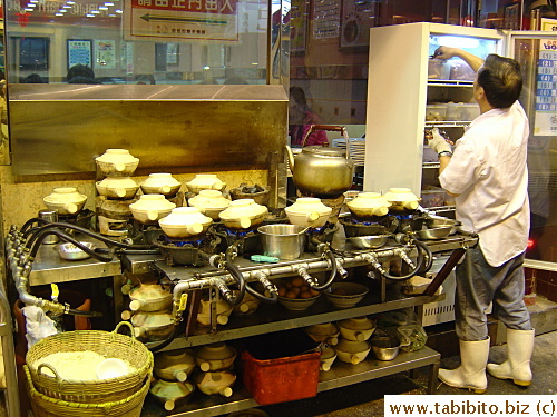 Different pot rice being cooked, even water in the kettle is cooked over a clay pot