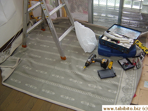The electrician's tools and rug to protect our floor