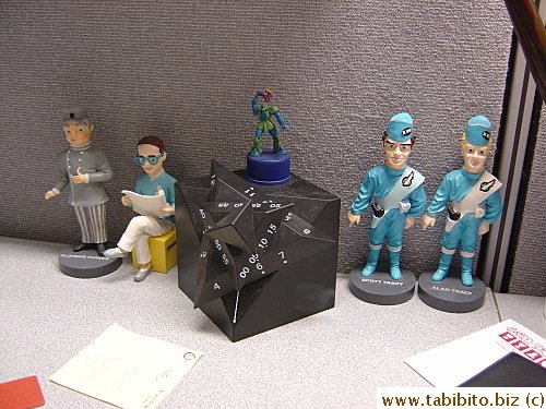 One guy has space-related figurines on the desk