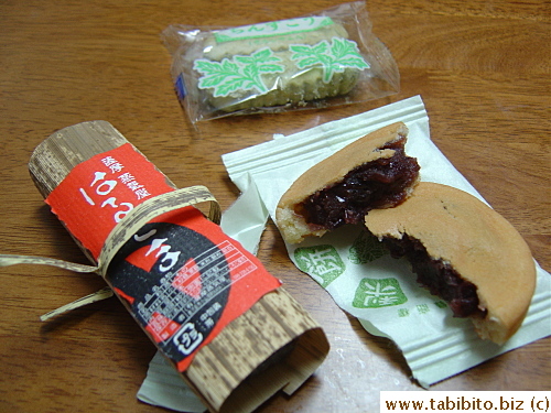 Omiyage trio: green cookies, Japanese pastry with red bean filling and a log of sweet jelly-like thing, only much firmer
