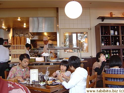 Semi-open kitchen occupies one side of the room