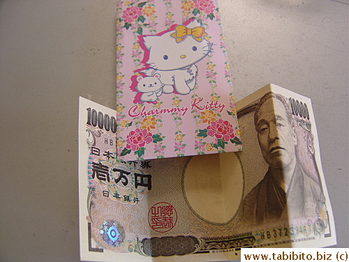 The money given by Mrs Y is stuffed inside a Hello Kitty envelope 