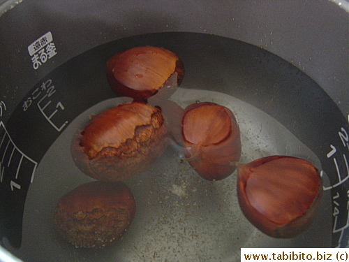 Soaking the chestnuts in hot water makes peeling the shell an easy job