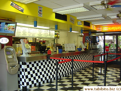 Counter.  Japanese menu is sitting next to the cups