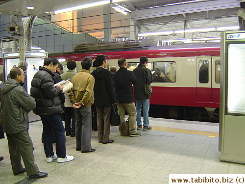 KL joined the queue on a platform at Shinagawa station to catch the train to Haneda airport