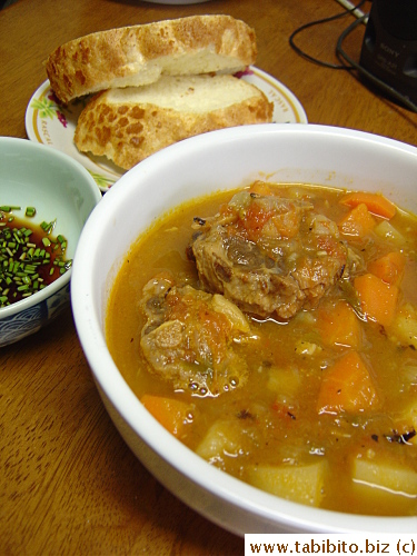 Oxtail soup and Dutch bread for lunch. The soy sauce with finely chopped scallions is a dipping sauce for the oxtails