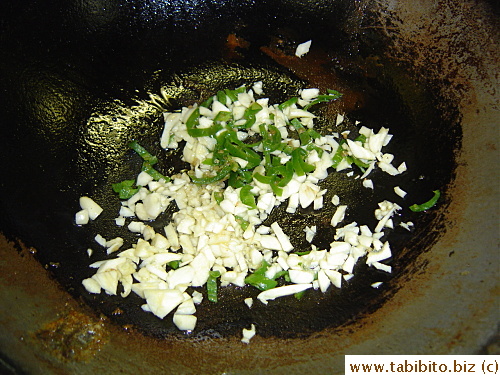 Then chopped garlic and jalopeno are fried