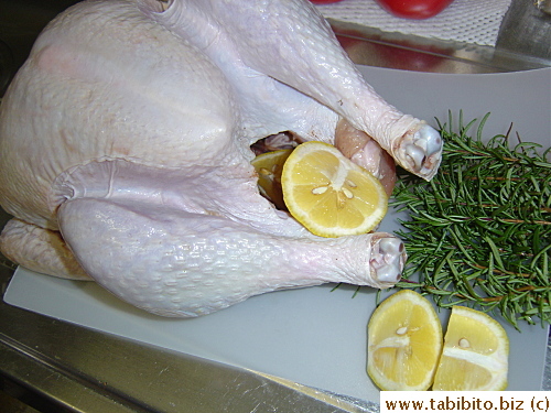 After 8 hrs of brining, the turkey's dried and the cavity slightly sprinkled with Cajun spices, stuffed with a quartered lemon and rosemary sprigs