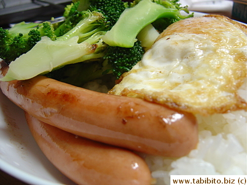 Our often-eaten lunch: Sausages, fried egg and vegetable over rice