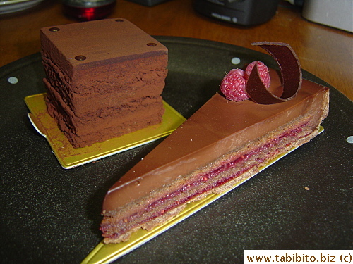 Chocolate and raspberry cake in front, chocolate mousse cake in the back