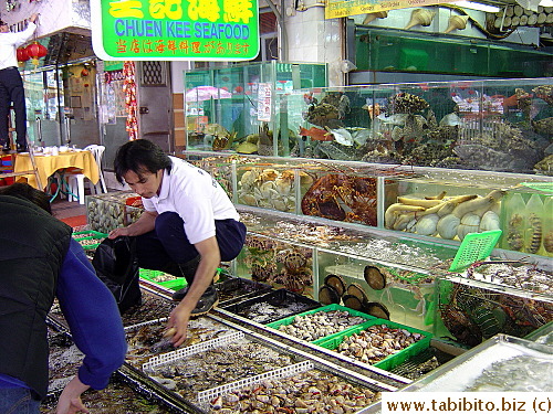 A staff helps customers pick their seafood of choice