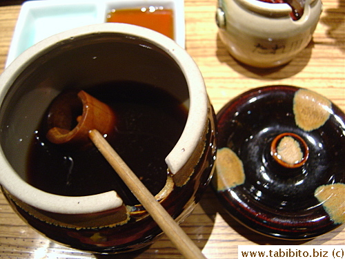 Old-fashioned wooden spoon in the soy sauce container