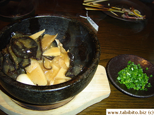 A Chinese dish: hot meat and veggie sauce poured over deep-fried rice squares in sizzling bowl 730Yen/$6