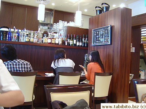 Front part of the restaurant with counter seats and tables