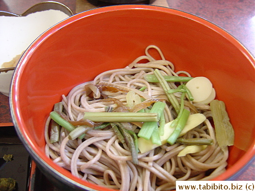 Soba with wild mountain veggies.  A staff constantly walked around with a tray of bowls of soba urging people to eat more