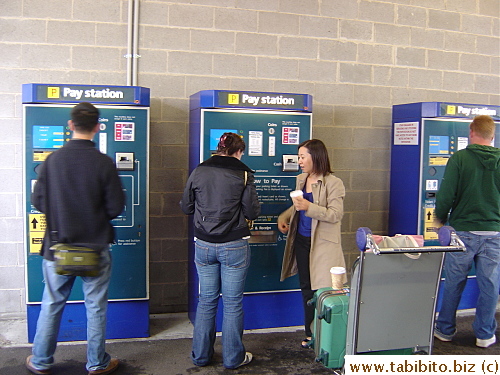 Parking in Sydney airport is achingly expensive:A$7/30 min.  Peter getting the parking ticket from one of the machines