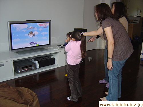 Rachel and the kids watch me play a fishing game.  Tiffany gets very nervous of me catching the 