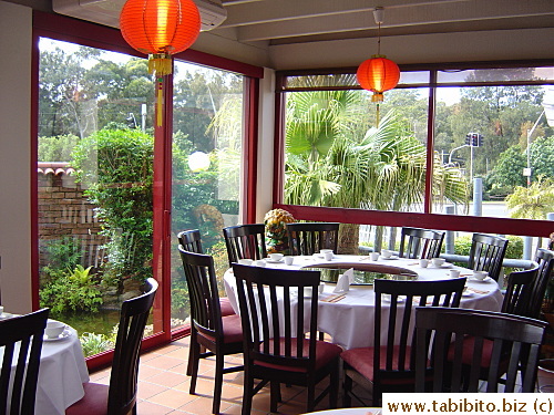 A covered terrace inside the restaurant which is surrounded by a pond with koi