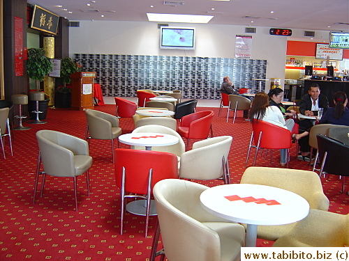Seating for a bar extends all the way to the restaurant's second entrance