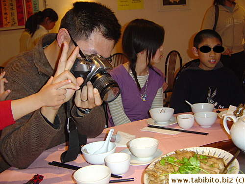 Peter takes pictures for his blog but manages to flash a V sign at us