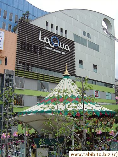A carousel in front of the mall. (Notice how the roller coaster runs through the upper right corner of the mall)