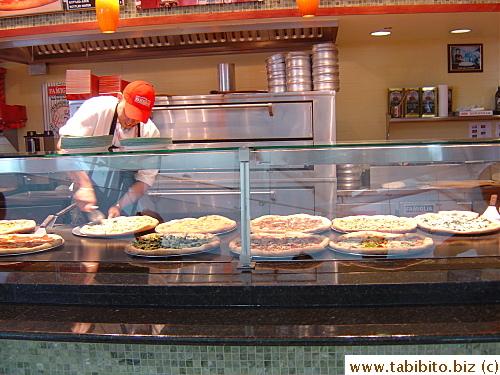 The man cutting freshly baked pizza