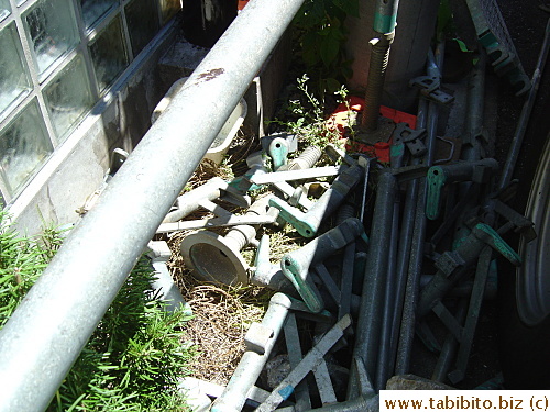 Heavy metal things were dropped and left over the shrubs when the workers went to lunch