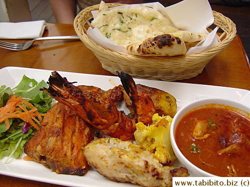 Lots of meat in KL's set: chicken maryland and breast, jumbo prawn, fish and a lone cauliflower, and he opted for garlic naan for his meal