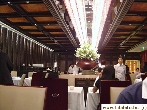 Long row of tables in the center of the restaurant