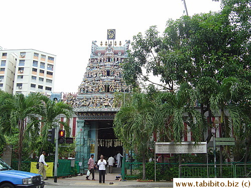 A temple on Seragoon Road, the man in the white shirt wasn't waiting to cross the road, he was praying to the sky with his slippers off