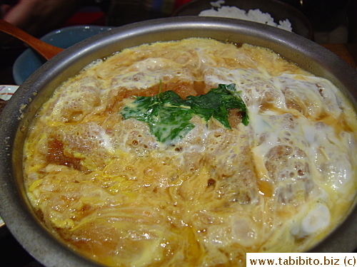Close-up of the pork chop in an eggy sweet sauce