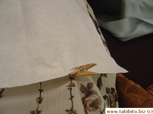 so you can clip it on your clothes to prevent the napkin from sliding off your lap