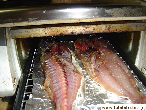 Grilling the fish (didn't realize the stove's this filthy till I took this picture!)