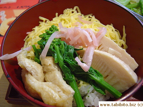 rice cooked in dashi broth topped with braised tofu pockets, bamboo tips, shredded egg, picked ginger and nanohana (a Japanese spring vegetable)