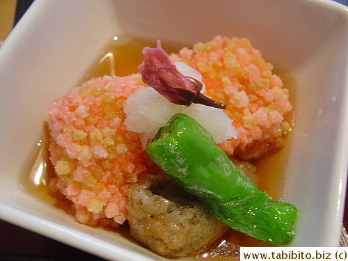 Deepfried soft tofu cubes garnished with namafu, grated daikon, shishito (Japanese chili) and a salted sakura