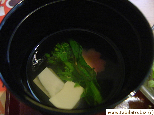 Clear broth with tofu and nanohana and a colorful namafu