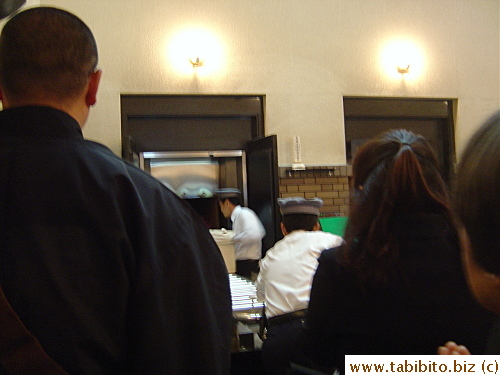 I took this picture behind the monk of the casket being rolled into the incineration room