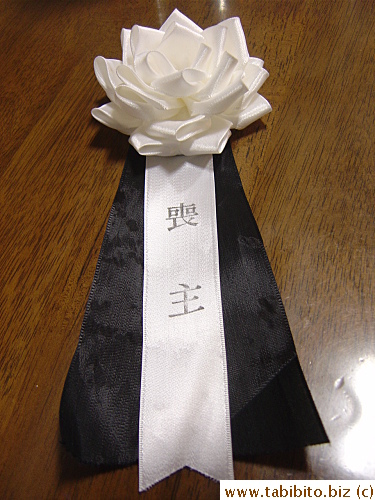 My friend, being the spouse of the deceased, wore this on her suit